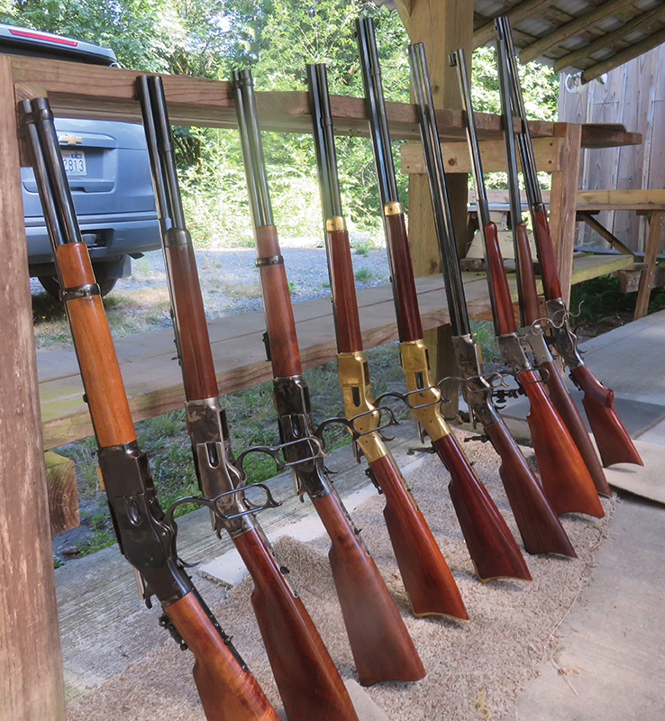 The 44-40 rifles are leaning against the bench, shortest to the longest.